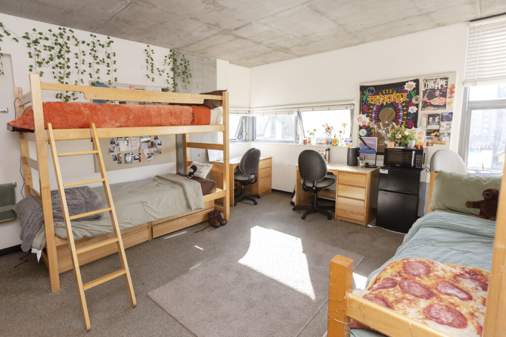 A room with a bunk bed and a single bed is shown.
